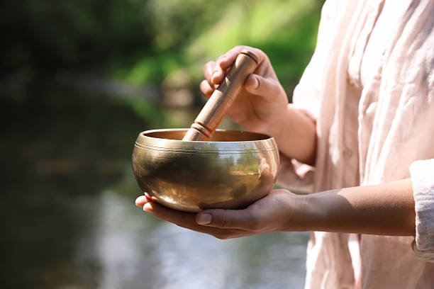 istock Woman with singing bowl in nature, closeup 2236279466
