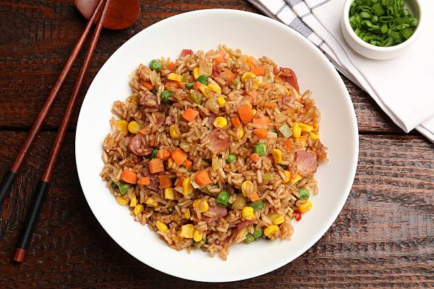 istock Tasty fried rice and chopsticks on wooden table, flat lay 2236279863