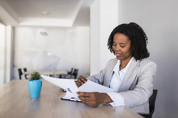 istock Professional businesswoman reviewing documents and working in office 2236281445