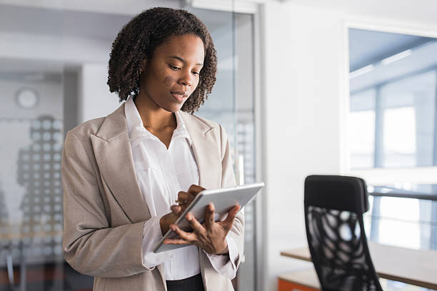 istock Black businesswoman using digital tablet in modern office 2236281468