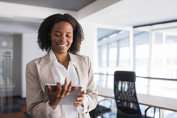 istock Smiling businesswoman using digital tablet in modern office 2236281469