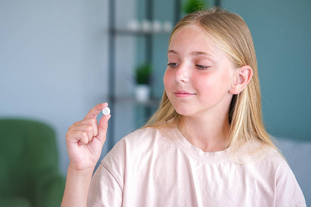 istock The child holds a pill in his hand 2236281502