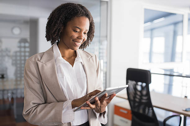istock African american businesswoman smiling while using digital tablet in office 2236281568