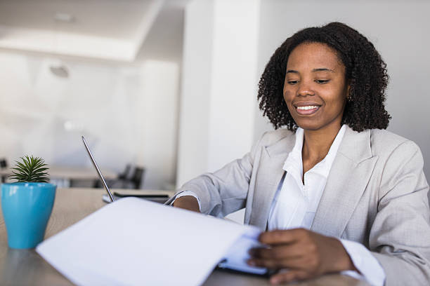 istock Professional black businesswoman reviewing documents in office 2236282483