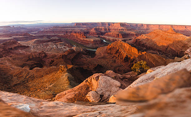istock Sunset Over Deep Canyon Cliffs With A Winding River Through Red Rock Landscape 2236283235