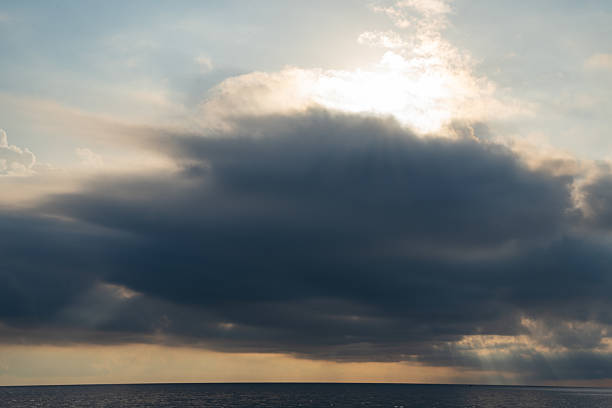 Bright clouds at sunset and waves