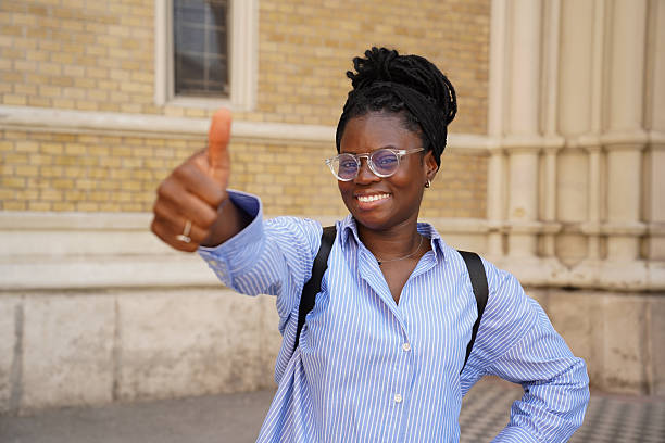 istock Confident Young Woman with Backpack in Front of University Building 2236284866
