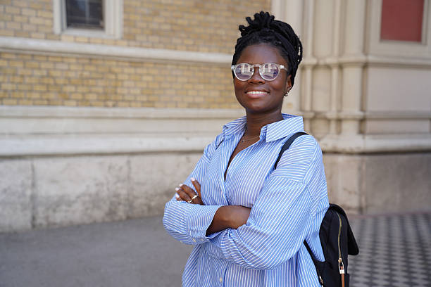 istock Confident Young Woman with Backpack in Front of University Building 2236284939