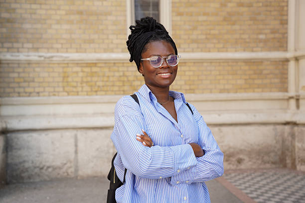 istock Confident Young Woman with Backpack in Front of University Building 2236284953