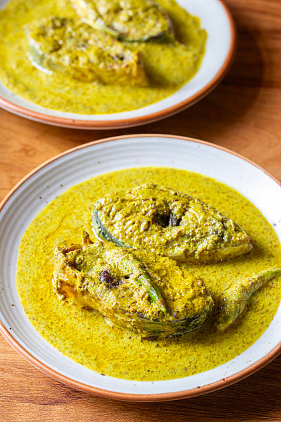 istock Traditional Bengali Hilsa Curry with Mustard Seeds, Aromatic Spices, Rich Flavors, Authentic Taste, Classic River Fish Delicacy, Savory Preparation, Perfect Dish for Special Occasions 2236286392