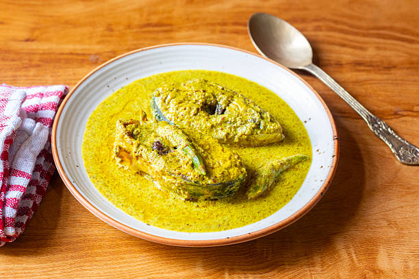 istock Traditional Bengali Hilsa Curry with Mustard Seeds, Aromatic Spices, Rich Flavors, Authentic Taste, Classic River Fish Delicacy, Savory Preparation, Perfect Dish for Special Occasions 2236286402