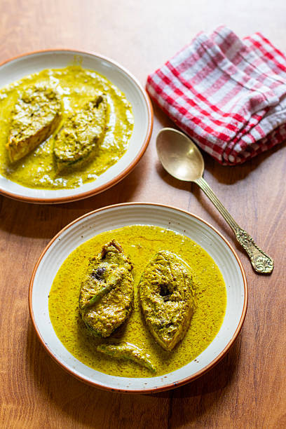 istock Traditional Bengali Hilsa Curry with Mustard Seeds, Aromatic Spices, Rich Flavors, Authentic Taste, Classic River Fish Delicacy, Savory Preparation, Perfect Dish for Special Occasions 2236286418