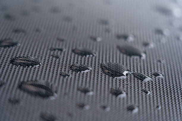 istock Macro view of water droplets on waterproof synthetic fabric – modern hydrophobic material used as a stylish garden chair backrest, showcasing durability and design 2236287063