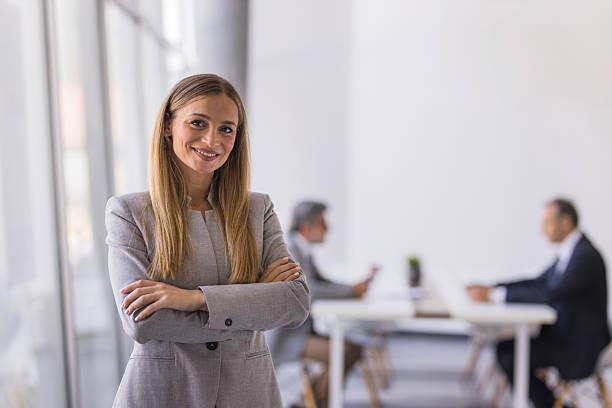 istock Confident businesswoman smiling in modern office environment 2236290102