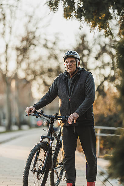 istock Man Standing Next to Bike on Sidewalk 2236290114