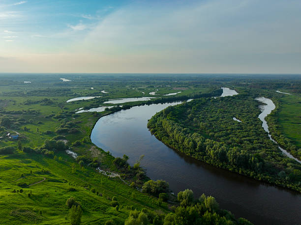 istock Winding river through a green landscape 2236291906