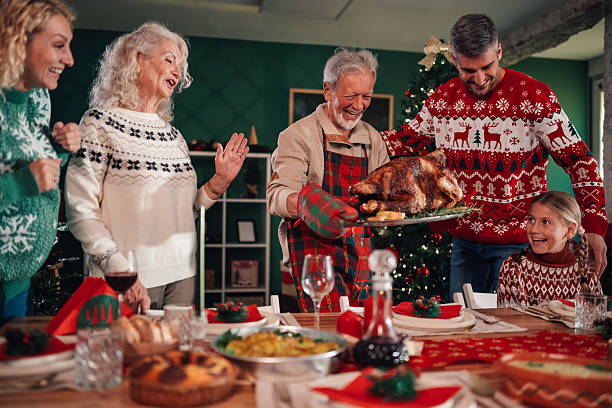 istock Family bringing roasted turkey to christmas dinner table 2236292472