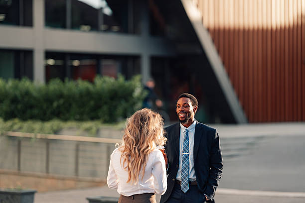 istock Business colleagues having outdoor conversation smiling and discussing 2236293638