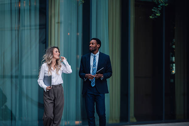 istock Business colleagues walking and talking during a break outside office building 2236293800