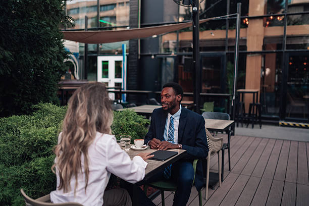 istock Business colleagues having coffee discussing project outdoors 2236293922