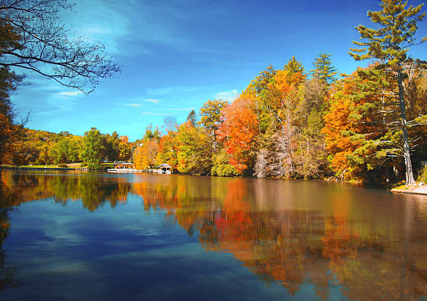 istock Tranquil lake reflecting beautiful fall colors of trees around. 2236310607