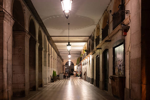 Girona - July 20 2025, Symmetric columns in the passage with restaurants at Independence Square in Girona, Spain