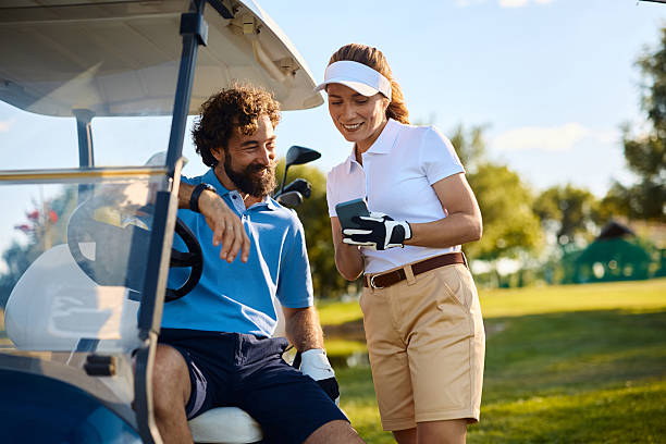 istock Happy couple of golfers using smart phone on the course. 2236313586