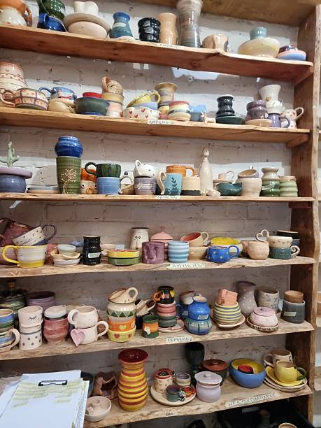 istock Handmade ceramic decorations and pottery on wooden shelves in artisan workshop 2236314007