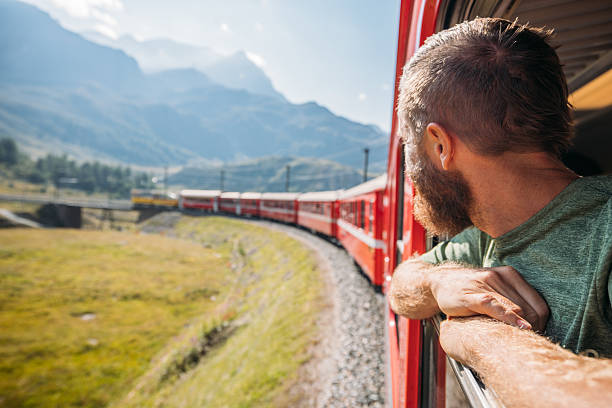 istock Man Enjoying Scenic Train Ride Through Mountains 2236314086