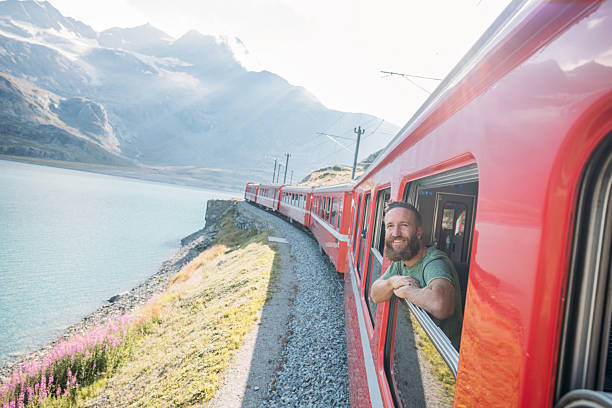 istock Smiling Man Enjoying Scenic Mountain Train Ride 2236314215