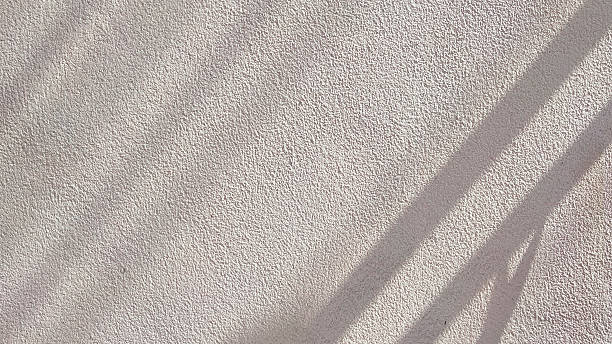 istock Rough texture of raw concrete wall background with sunlight and shadow on surface 2236317782