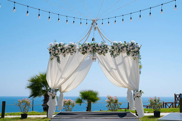 istock White canopy with draped fabric in park by the sea. 2236318980