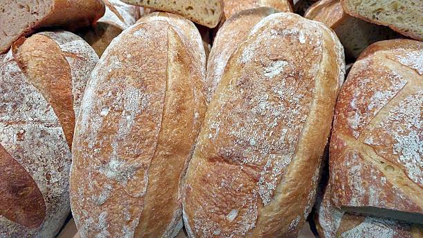 istock Different Types of Freshly Baked Bread Loaves Arranged Together for Display in a Bakery 2236319513