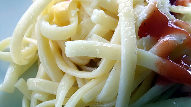 Spaghetti Plated With a Vibrant Twist of Sauce for a Delightful Culinary Experience
