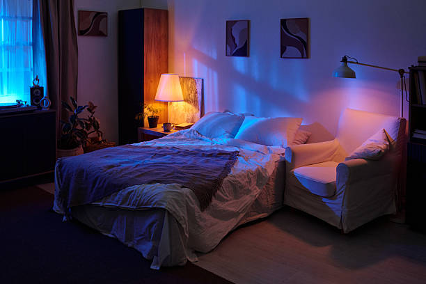 istock Empty Modern Bedroom Illuminated by Blue and Purple Ambient Lighting at Night 2236320211