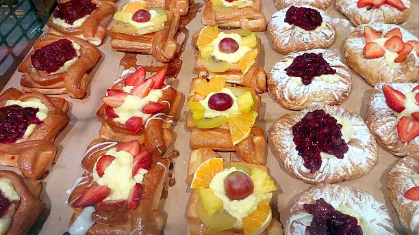 istock Sweet Pastries Beautifully Arranged in Rows at a Bakery Showcasing Vibrant Fruit Toppings 2236320241