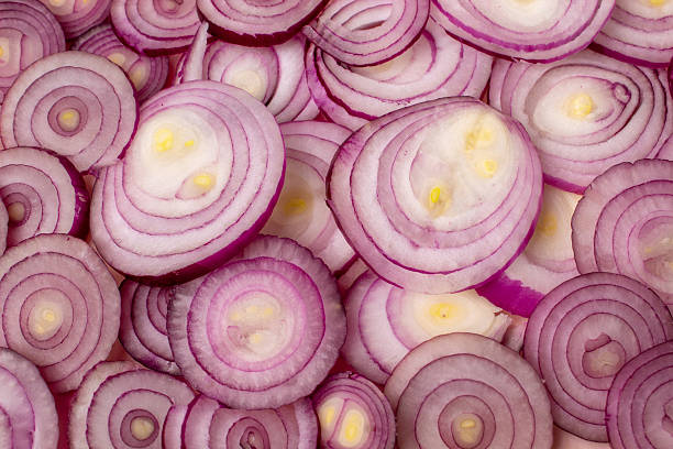 istock Purple onion rings arranged on a flat surface. Background 2236320433