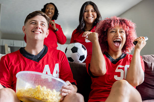 istock People gathered on couch to watch live soccer match 2236320783