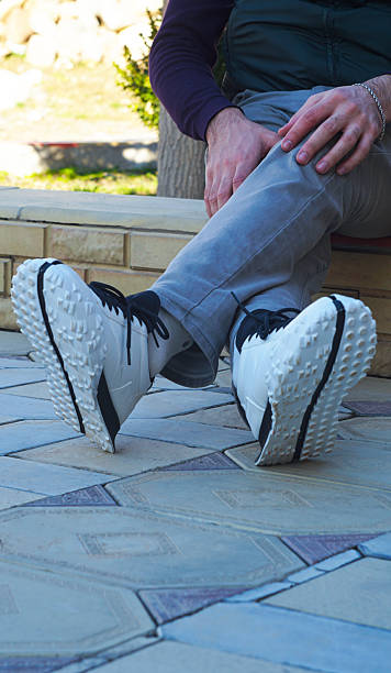 istock white sneakers on male feet 2236321136