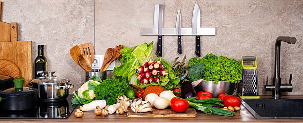 istock Fresh vegetables and cooking tools arranged in a modern kitchen for healthy meal preparation 2236325735
