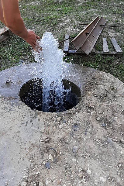 istock Artesian Well Fountain With Craftsman Washing Hands in a Natural Setting During Daylight 2236327320
