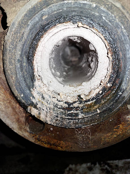 istock Pipe With Limestone Deposits Inside Showing Buildup in an Industrial Setting 2236327846