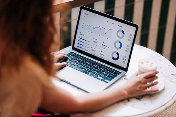 istock Professional Analyzing Business Metrics on Laptop at Cozy Workspace 2236328633