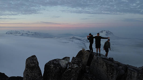 istock Three mountaineers stand on mountain summit 2236328929