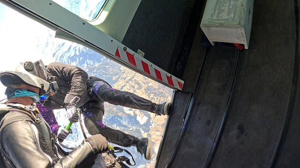 istock Trapeze fliers leave plane, above mountain landscape 2236329064