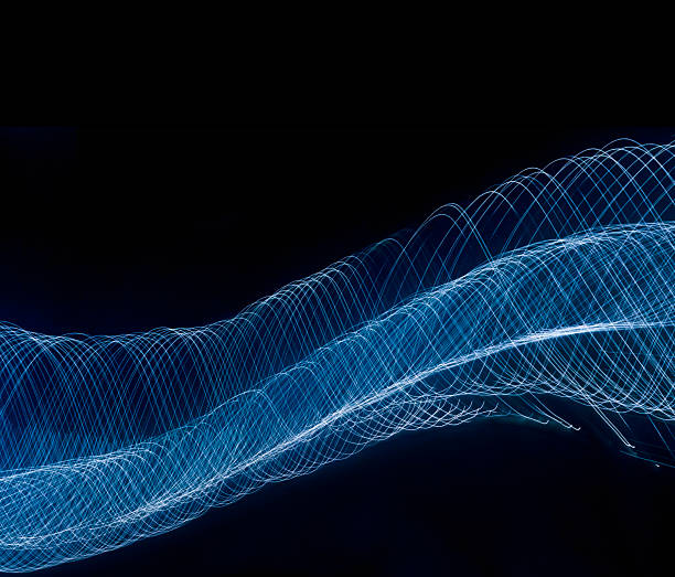 Conceptual image of flowing light trail on black background