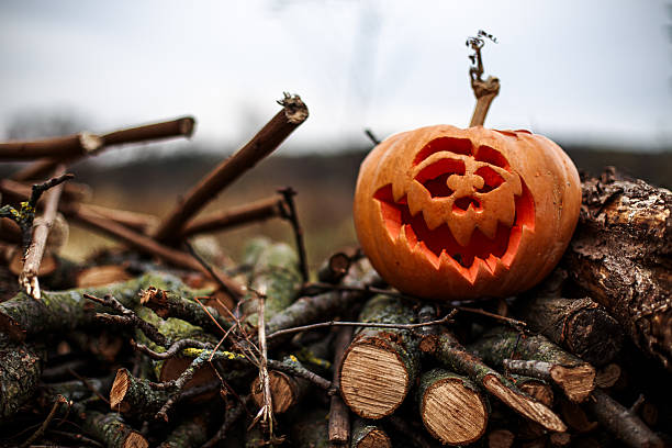 Glowing pumpkin with sinister face illuminating the darkness of Halloween night.