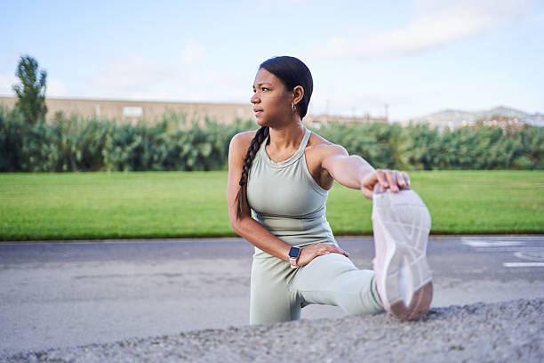 istock Young sportswoman stretching legs in a park before running 2236331032