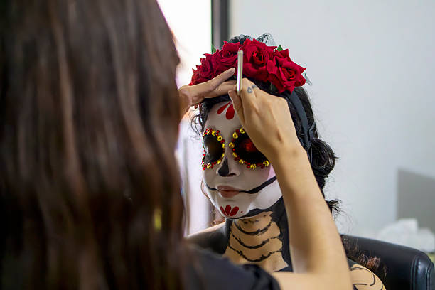 Make-up artist adding details to the catrina