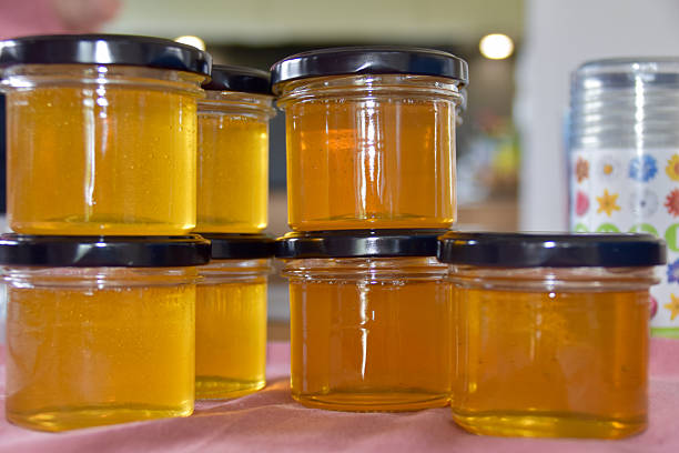 istock Stack of clear glass jars filled with golden honey 2236331797